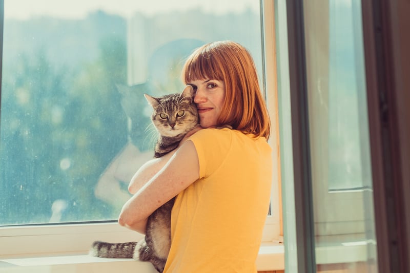 cat behaviorist woman hugging a cat